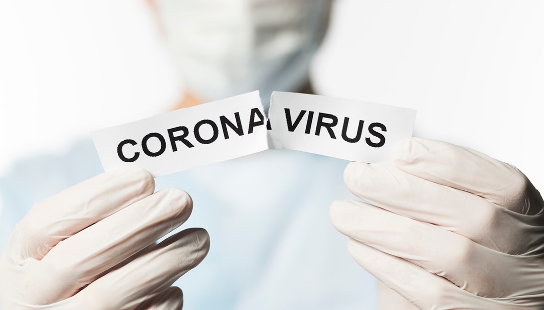 Hands Ripping Paper that Says Coronavirus